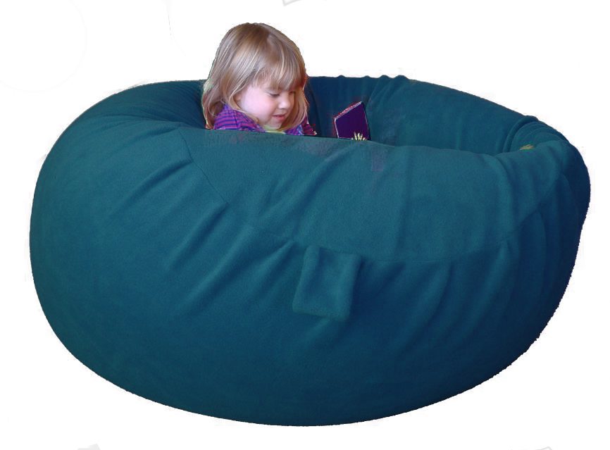 A child lying back in a bottle-green fleece sensory beanbag