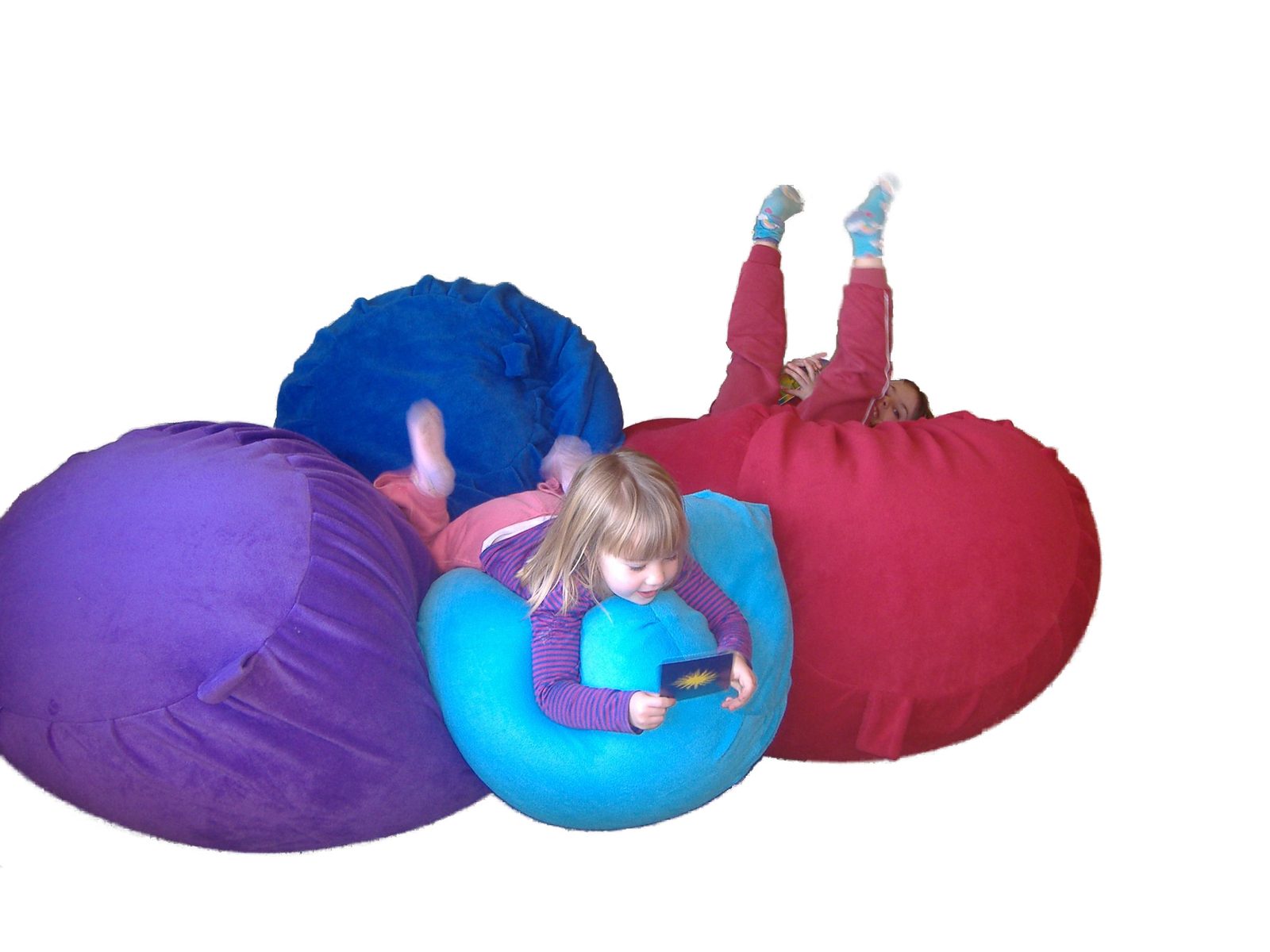 Four sensory beanbags in different sizes and colours grouped together, with children resting on two of them