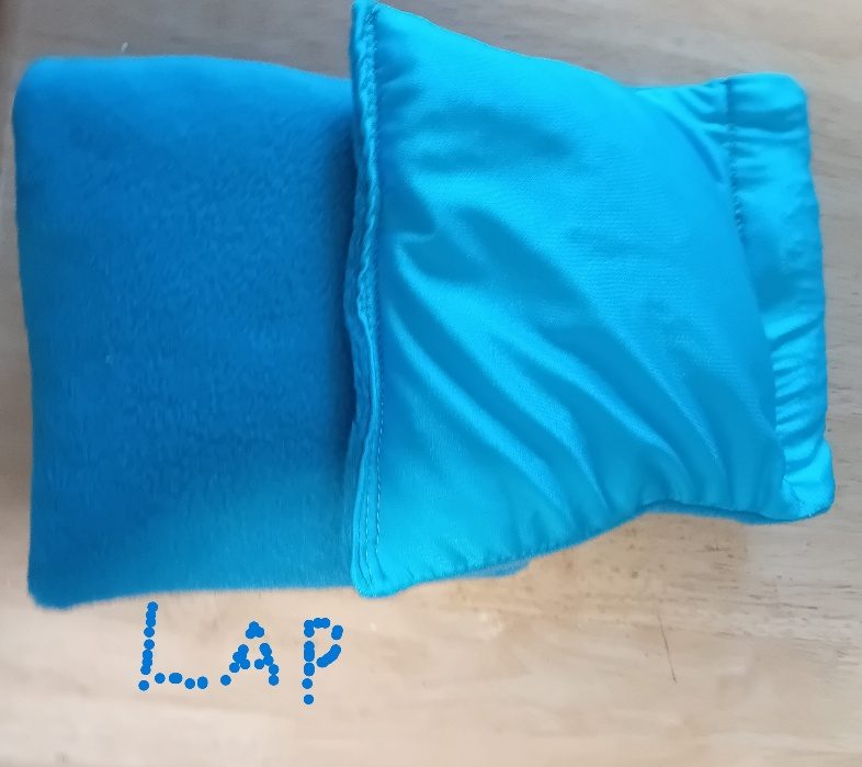 Two 4 lb weighted lap pads side by side, one in teal fleece and one in shiny turquoise lycra